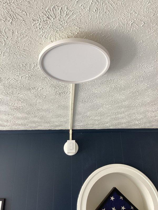 Installed wire mold raceway system in two rooms to relocate lighting fixtures from existing wall-mounted positions to center ceiling locations. Mounted new junction boxes at mid-ceiling points, ran surface-mounted conduit from original fixture locations, and installed customer-supplied LED light fixtures with wireless three-way switching capability in room lacking existing switch control.