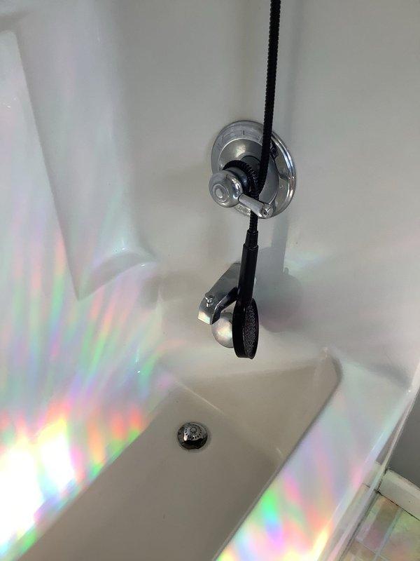 Responded to service call for leaky tub/shower in 20-year-old residential property. Upon inspection, identified corroded drain kit as source of leak requiring complete replacement. Removed existing deteriorated drain assembly and installed new drain kit with updated components to restore proper function and eliminate water leakage. Tested installation to verify watertight seal and proper drainage operation.