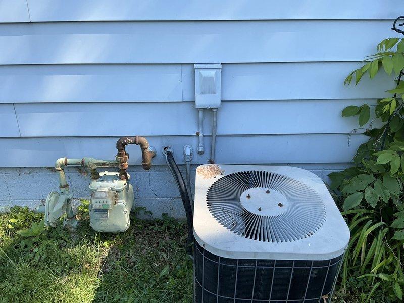 Completed estimate for replacement of 37-year-old air conditioning condenser unit and Lennox WhisperHeat furnace system. Both units are currently operational but have reached end of service life, showing visible signs of aging and weathering on outdoor components. Assessed existing outdoor condenser installation, electrical disconnect, gas meter connections, and basement furnace with ductwork to provide comprehensive replacement recommendations for complete HVAC system upgrade.