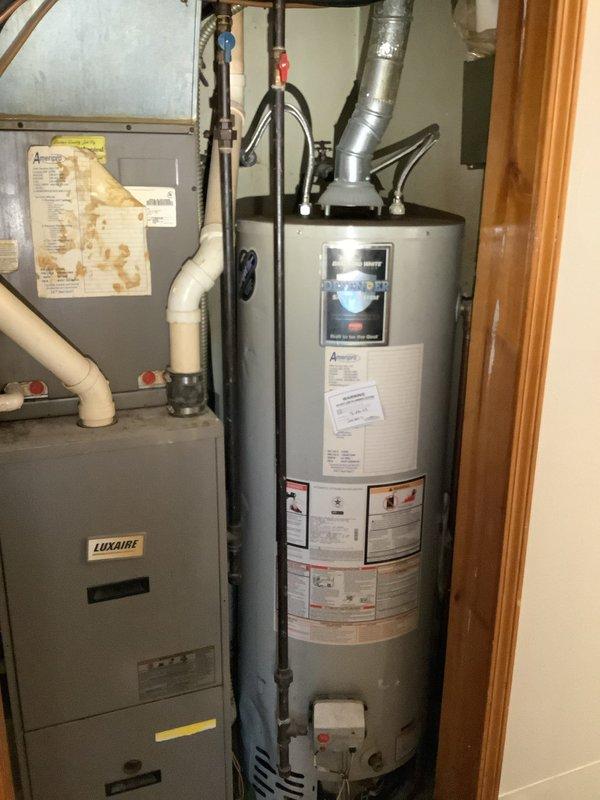Provided estimate for water heater replacement and installation of new supply lines. Assessed existing Bradford White 40-gallon natural gas water heater (Model RG240T6N, 40,000 BTU) located in mechanical room alongside HVAC equipment. Documented current installation configuration with existing plumbing lines running beneath concrete slab. Quoted alternative routing option to run new water supply lines vertically rather than connecting to existing under-slab piping, which would eliminate potential issues with concealed piping and provide easier future access for maintenance or repairs.