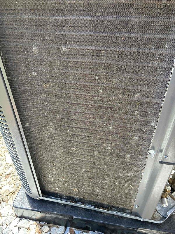 Completed routine summertime maintenance on approximately 18-month-old air conditioning unit with no reported issues. Performed standard tune-up inspection, noting condenser coil had accumulated significant dirt, dust, and debris buildup across the fins. Inspected electrical control panel and wiring harness, which appeared clean, properly organized with secure zip ties, and showed no signs of damage or corrosion.