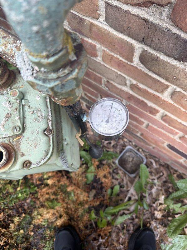 Responded to reported gas leak in utility room. Upon arrival, performed comprehensive inspection of exterior gas meter assembly and associated piping. Conducted pressure test on gas system to identify source of leak. Inspected all connections, valves, and fittings at meter location, noting significant weathering and corrosion on exterior components including deteriorated paint, rust spots, and oxidation on metal pipes and meter housing. Verified system integrity and documented conditions with photographic evidence. Confirmed leak status and ensured safe operating conditions of gas delivery system.