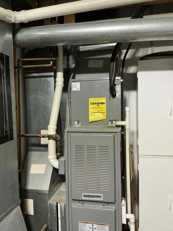 Completed on-site assessment and provided estimate for HVAC system replacement involving two separate systems: main level 20-year-old furnace and air conditioning unit, and secondary upstairs addition system approximately 10+ years old. Evaluated existing Comfortmaker furnace installation, ductwork configuration, condensate drainage system, refrigerant line routing, and humidifier integration to develop comprehensive hybrid heating system options tailored to the home's dual-zone setup.