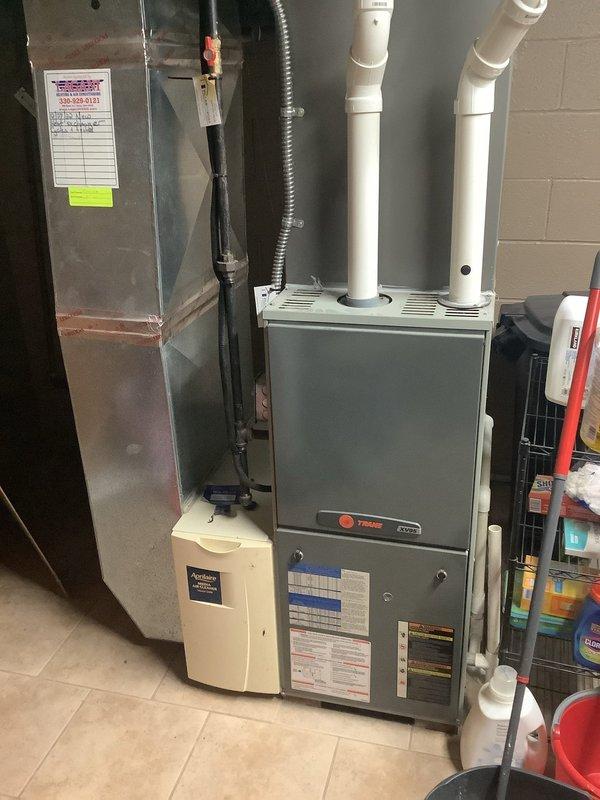 Completed annual furnace maintenance on Trane gas furnace system. Performed comprehensive inspection including visual examination of heat exchanger, burner assembly, and venting system. Checked and cleaned burners, verified proper ignition sequence, and tested all safety controls including flame sensor and limit switches. Inspected PVC intake and exhaust venting for proper installation and clearances. Verified humidifier operation and checked electrical connections throughout system. Tested furnace operation through complete heating cycle, confirmed proper airflow, and measured temperature rise within manufacturer specifications. All components found in good working condition with no deficiencies noted.
