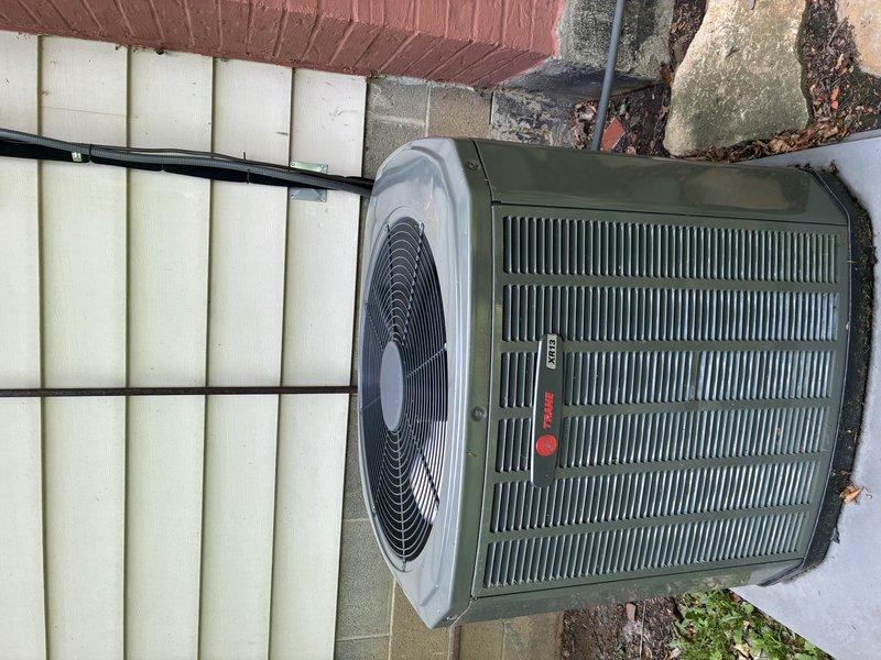 Completed MVP cooling maintenance visit on 14-year-old Trane condenser unit. Performed comprehensive system inspection including electrical components, capacitor, contactors, and wiring connections within the unit compartment. Documented equipment condition through photography, noting unit positioned on concrete pad with proper clearances and overall normal operational appearance with no visible damage or excessive wear to exterior panels or fan assembly.