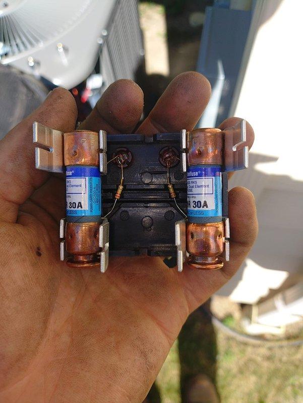 Completed installation of 90% efficiency furnace and air conditioning system. Replaced worn 30-amp fuse assemblies showing significant oxidation and discoloration, ensuring proper electrical protection for the new equipment. Verified system operation with temperature readings confirming proper functionality of both heating and cooling components.
