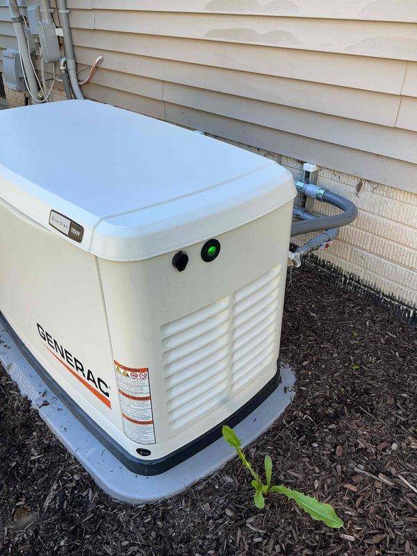 Responded to service call for Generac residential standby generator displaying red battery warning light. Performed comprehensive system diagnostic and visual inspection of unit. Upon arrival, confirmed generator was displaying battery check indicator, but further testing revealed the system was functioning properly with battery charging correctly and all operational parameters within normal limits. Cleared warning light, verified proper generator operation, and confirmed unit returned to normal standby mode with green indicator light displayed.