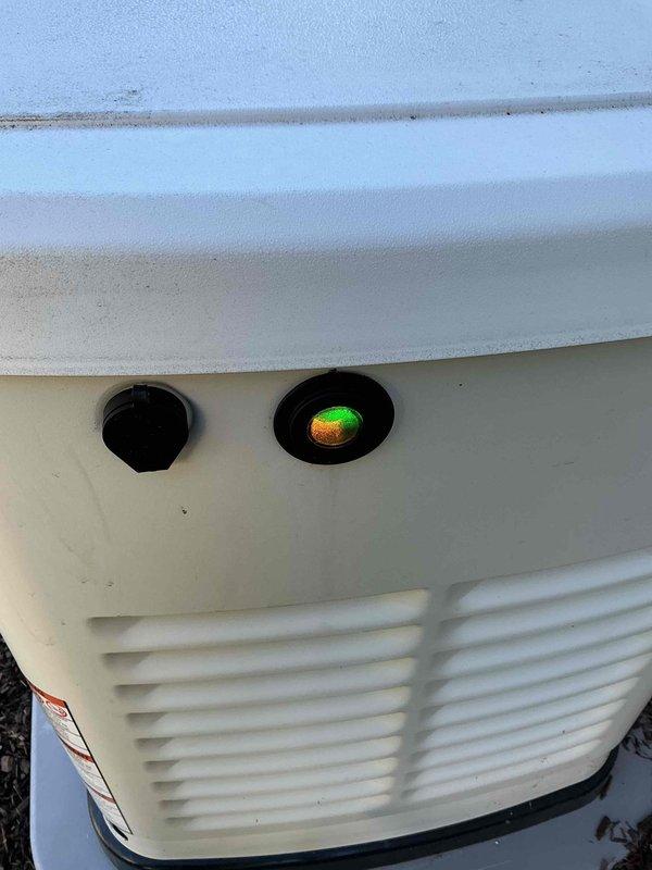 Responded to service call for Generac residential standby generator displaying red battery warning light. Performed comprehensive system diagnostic and visual inspection of unit. Upon arrival, confirmed generator was displaying battery check indicator, but further testing revealed the system was functioning properly with battery charging correctly and all operational parameters within normal limits. Cleared warning light, verified proper generator operation, and confirmed unit returned to normal standby mode with green indicator light displayed.