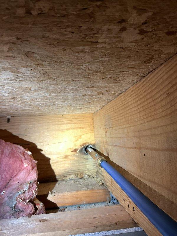 Responded to a burst pipe repair at residential property where the supply line to an exterior hose bib had failed during winter freeze conditions. Upon arrival, confirmed water supply had been shut off and inspected both interior and exterior locations. In the basement, located the damaged copper supply line in the drop ceiling area where water had leaked and saturated ceiling tiles. Assessed the extent of freeze damage to the piping system running through the uninsulated crawl space. Removed affected section of burst pipe and installed new copper piping with proper fittings and soldered connections. Verified exterior hose bib was functioning properly and reconnected supply line. Pressure tested all repairs to ensure no additional leaks were present. Restored water service to the exterior faucet and confirmed proper operation throughout the system.