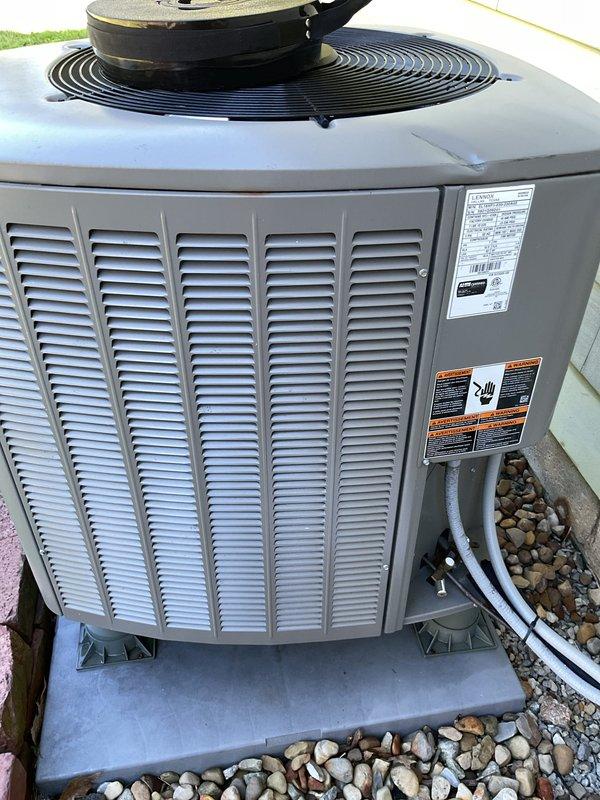 Responded to service call for non-operational heat pump and air exchanger system. Upon arrival, inspected three-year-old outdoor heat pump unit and associated electrical connections. Performed diagnostic evaluation of control panel wiring, terminal connections, and power supply circuits. Examined refrigerant line connections, unit mounting, and overall system condition. Documented equipment specifications and current operational status through visual inspection of both outdoor condensing unit and electrical control components for troubleshooting purposes.