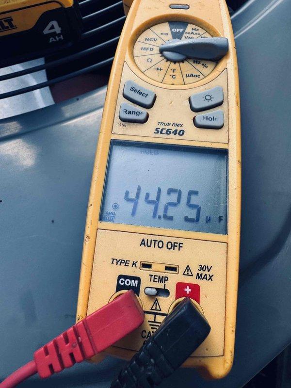 Completed comprehensive A/C tune-up on outdoor condensing unit with no reported issues. Performed electrical diagnostics using digital multimeter, measuring amperage draw at 23.38A and verifying voltage readings at 442V to ensure system operating within manufacturer specifications. Inspected capacitor, wire connections, and electrical components inside cabinet, confirming all connections secure and equipment functioning properly.