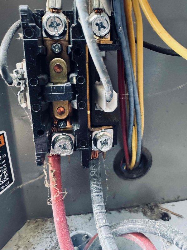 Completed MVP cooling maintenance visit on 8-year-old system. Performed comprehensive inspection of electrical components and control systems. Documented existing wire insulation deterioration at terminal block connections, noting fraying on red and gray conductors where they interface with brass terminal screws. Inspected multi-board control panel configuration with green circuit boards and associated wiring harnesses. All colored wire connections to control modules verified secure. System operational at time of service completion.