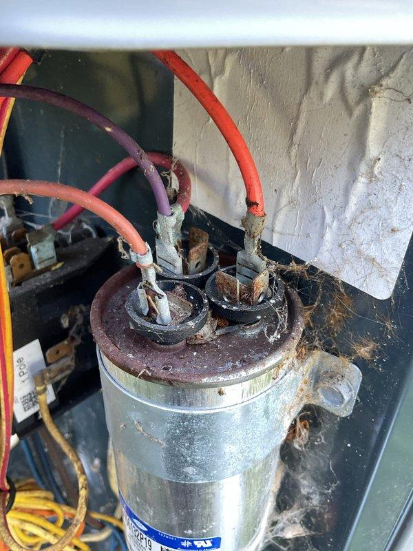 # HVAC Cooling Maintenance Completed

Performed comprehensive cooling system maintenance on residential air conditioning unit. Conducted thorough inspection of electrical components, revealing severely corroded capacitor with deteriorated top surface and aged wiring connections. Assessed overall system condition, noting significant dust and debris accumulation throughout cabinet interior indicating extended service interval. Evaluated all electrical connections, refrigerant lines, and mechanical components. System showed normal environmental wear consistent with outdoor installation and extended operation period. Documented component conditions with detailed photography for service records and future reference.