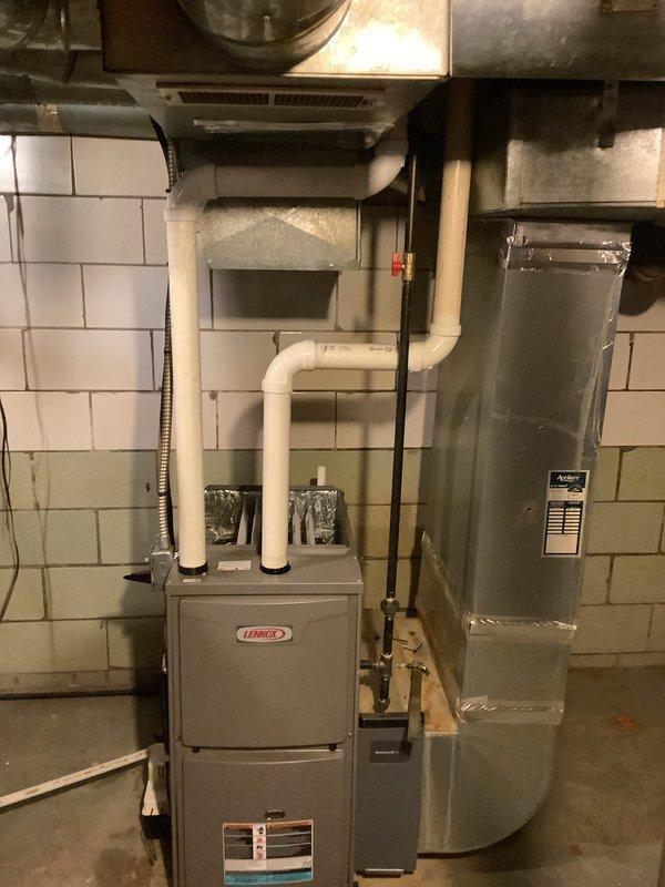 Completed installation of Lennox air conditioning system with matching evaporator coil. Installed outdoor condensing unit on concrete pad with proper clearances, mounted electrical disconnect box, and ran refrigerant lines to indoor air handler. Indoor evaporator coil was installed adjacent to existing Lennox furnace in basement mechanical room, with copper refrigerant lines properly brazed and insulated. Connected condensate drain line with PVC piping routed to exterior. System was evacuated, charged to manufacturer specifications, and tested for proper operation. All electrical connections completed per code requirements and system confirmed operational with proper airflow and temperature differential.