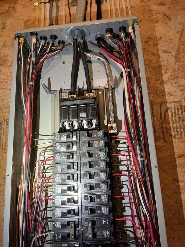 Conducted on-site assessment of existing electrical system in preparation for pool installation. Inspected main electrical panel in basement storage area, documented current circuit breaker configuration and available capacity, and photographed panel layout showing conductor routing and connection points to determine feasibility and requirements for dedicated pool circuit installation.