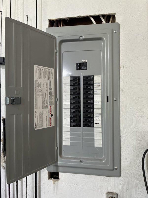 Installed electrical service for new septic system installation. Configured circuit breaker panel with appropriate circuits and labeling, ensuring proper power distribution for septic equipment operation. Completed wiring installation in utility area with all circuits tested and operational per code requirements.