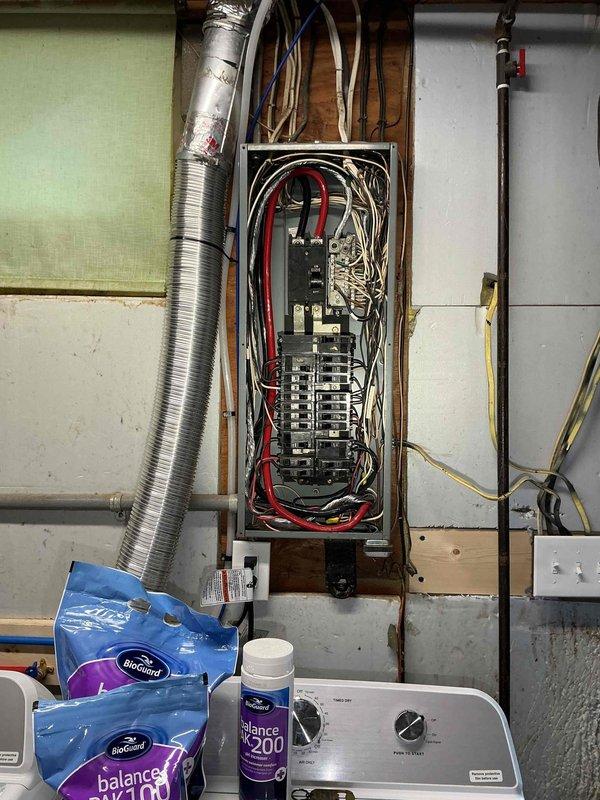 Conducted comprehensive site assessment for Kohler generator installation. Evaluated existing electrical service panel and infrastructure to determine optimal integration points for automatic transfer switch and generator connection. Documented current electrical panel configuration, circuit breaker arrangement, and available capacity for generator tie-in. Assessed utility room layout, clearance requirements, and conduit routing options for generator wiring. Photographed electrical panel interior showing main breaker, branch circuit configuration, and existing wire management to support detailed installation planning and permit documentation.