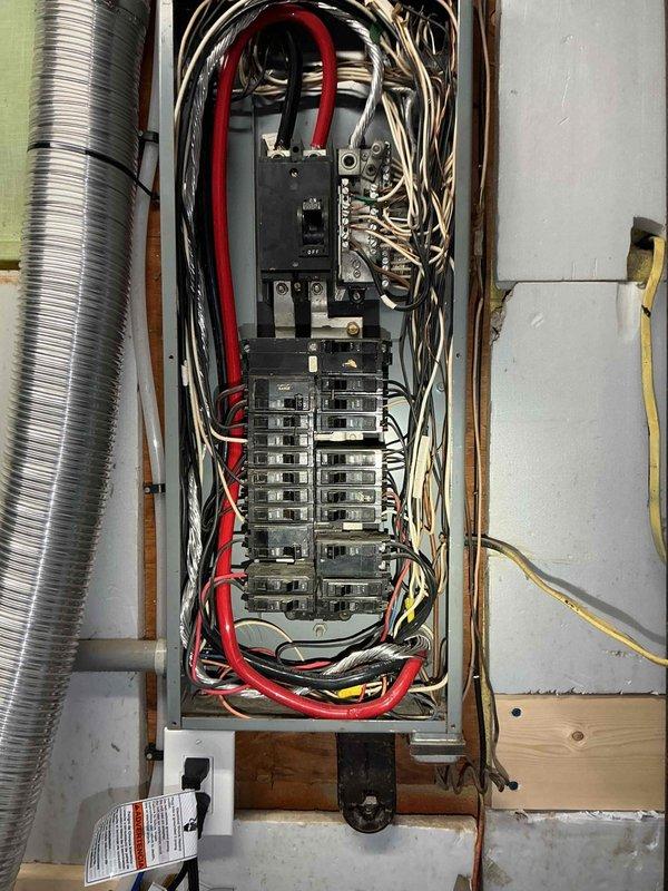 Conducted comprehensive site assessment for Kohler generator installation. Evaluated existing electrical service panel and infrastructure to determine optimal integration points for automatic transfer switch and generator connection. Documented current electrical panel configuration, circuit breaker arrangement, and available capacity for generator tie-in. Assessed utility room layout, clearance requirements, and conduit routing options for generator wiring. Photographed electrical panel interior showing main breaker, branch circuit configuration, and existing wire management to support detailed installation planning and permit documentation.