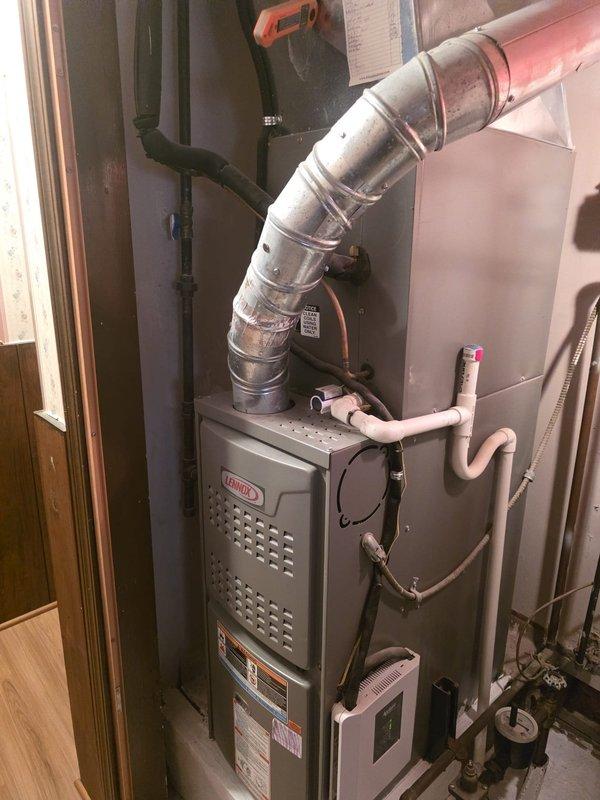 Completed MVP cooling maintenance visit on residential Lennox furnace system. Performed comprehensive inspection of HVAC unit, ductwork connections, and associated components including PVC exhaust/intake piping. Verified all mechanical connections, examined system operation, and documented equipment condition through photographic records. Unit found operating within normal parameters with no immediate service concerns identified.
