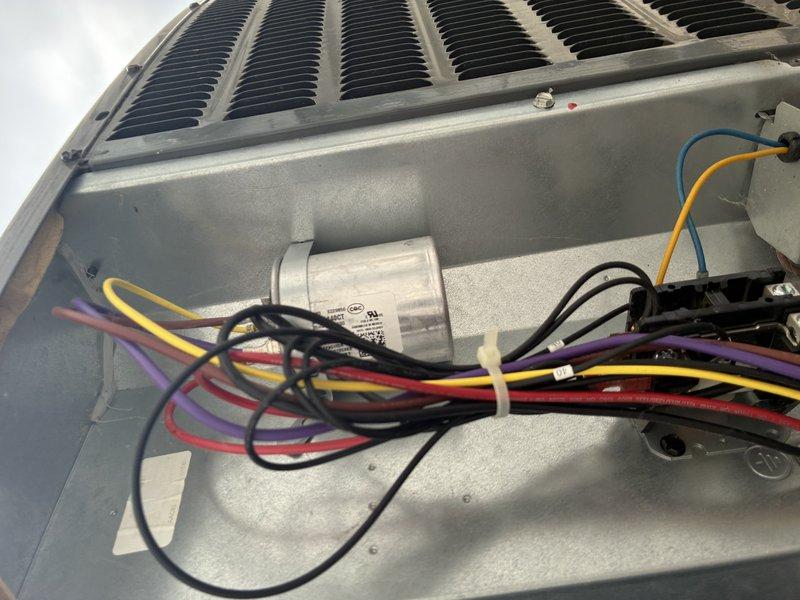 Completed preventive maintenance tune-up on a three-year-old residential air conditioning system. Inspected outdoor condensing unit electrical components including capacitor, contactor, and wiring connections; all connections found secure with no signs of deterioration. Verified condenser coil condition showing no blockage or damage. Examined indoor air handler unit in attic installation; confirmed proper mounting, ductwork connections, and overall system operation. System operating within normal parameters with no deficiencies noted.