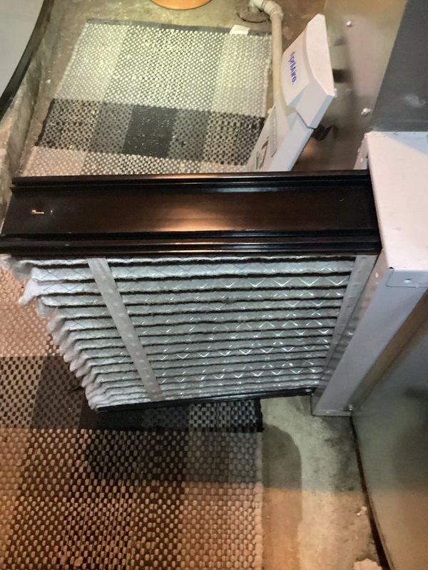 Performed routine maintenance visit on a 5-year-old air conditioning system. Upon inspection, discovered extensive ice buildup on the evaporator coil fins, indicating a potential refrigerant issue, airflow restriction, or system malfunction. Documented the frozen coil condition and associated mechanical components including copper refrigerant lines, service valves, and circulator pump assembly for further diagnostic evaluation and necessary repairs.