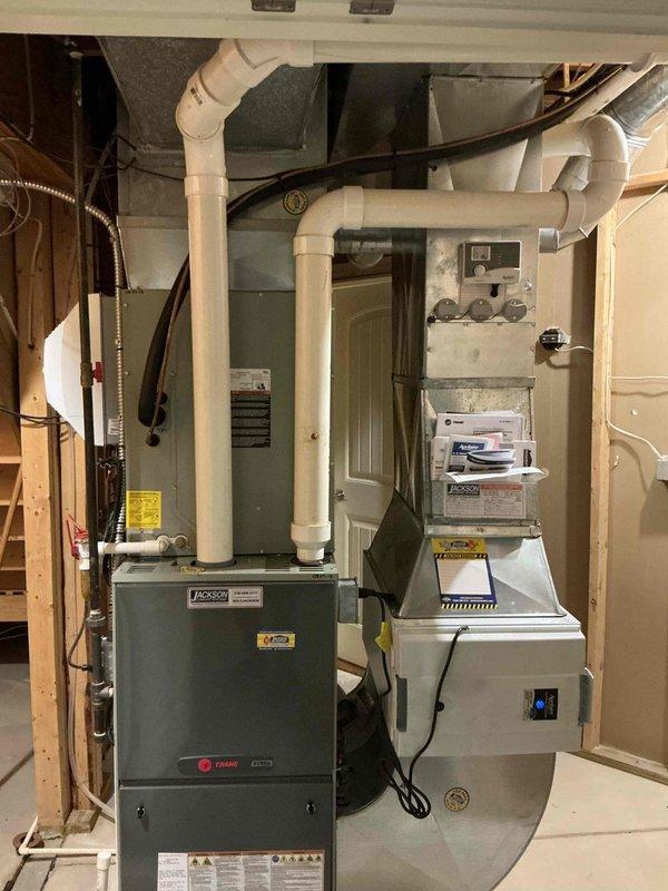 Conducted on-site evaluation for furnace replacement estimate at residential property. Assessed existing Trane furnace installation in basement mechanical room and exterior AC condenser unit. Documented current HVAC system configuration including venting, ductwork, electrical connections, and equipment placement to provide comprehensive replacement options.