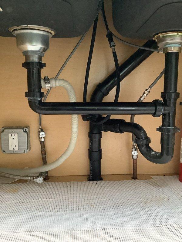 Responded to service call for kitchen faucet replacement where the original spigot had rusted off and required installation. Successfully removed the deteriorated faucet assembly and installed a new brushed stainless steel pull-down kitchen faucet with high arched spout and side lever handle on the double-basin stainless steel sink. Verified all under-sink plumbing connections, supply lines, and shut-off valves were secure and functioning properly with no leaks detected upon completion.