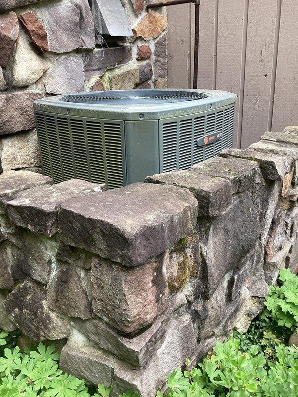 Performed preventative maintenance tune-up on two residential air conditioning systems. Inspected outdoor condenser units, both showing significant age with weathered casings and biological growth on exterior surfaces. Verified proper operation of compressor, condenser fan motor, and electrical components on both units. Checked refrigerant levels and pressures within manufacturer specifications. Cleaned condenser coils to remove accumulated debris and organic matter. Inspected electrical connections and tightened terminals as needed. Evaluated airflow through ventilation louvers and confirmed adequate clearance around units for proper operation. Both systems operating within normal parameters upon completion of tune-up service.