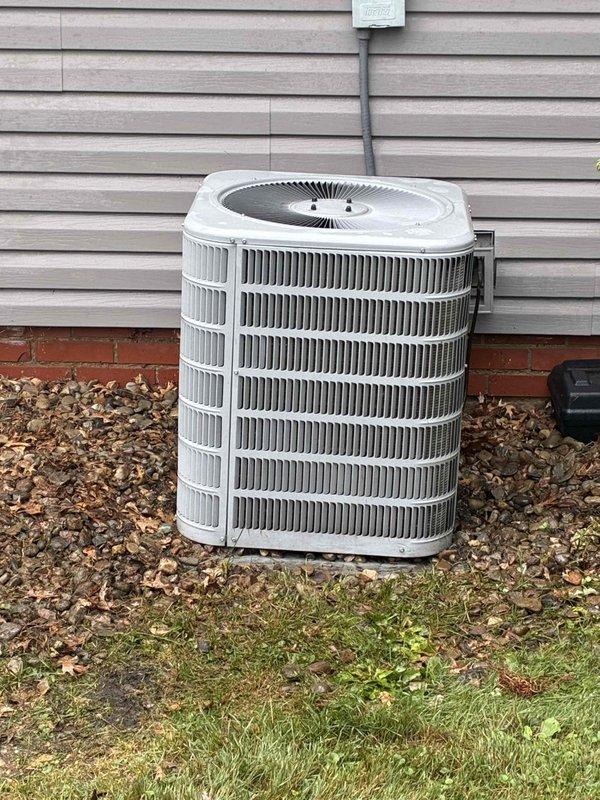 Completed MVP cooling maintenance visit on residential HVAC system. Addressed outdoor condensing unit requiring cleaning by removing grass clippings and debris from coil fins to restore proper airflow and heat transfer efficiency. Inspected indoor air handler and ductwork, noting evidence of previous moisture intrusion on vertical supply duct requiring sealing of joints to prevent future air leakage. Replaced 16x20 furnace filter as requested. Cleaned exterior condenser coil and surrounding area to manufacturer specifications, removing accumulated organic material from base and perimeter. Evaluated condensate drainage system and confirmed proper operation of all mechanical components during system runtime test.