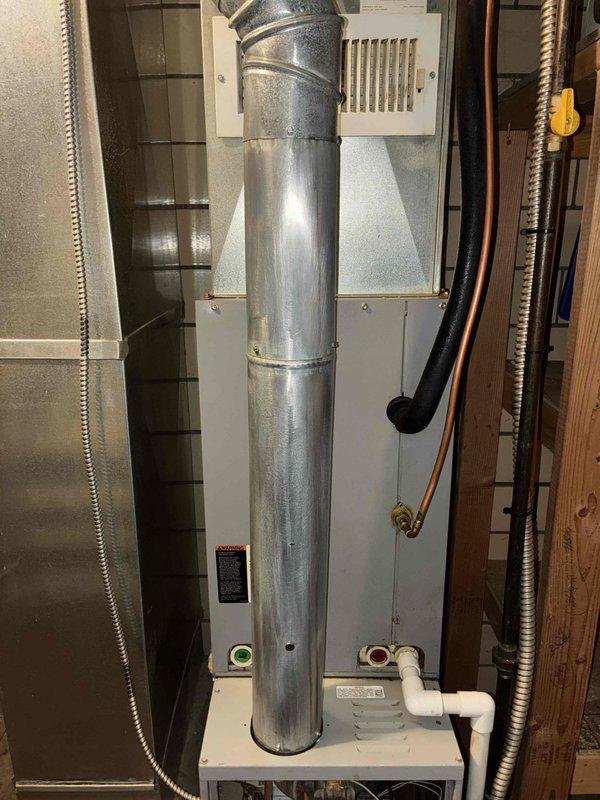 Completed MVP cooling maintenance visit on residential HVAC system. Addressed outdoor condensing unit requiring cleaning by removing grass clippings and debris from coil fins to restore proper airflow and heat transfer efficiency. Inspected indoor air handler and ductwork, noting evidence of previous moisture intrusion on vertical supply duct requiring sealing of joints to prevent future air leakage. Replaced 16x20 furnace filter as requested. Cleaned exterior condenser coil and surrounding area to manufacturer specifications, removing accumulated organic material from base and perimeter. Evaluated condensate drainage system and confirmed proper operation of all mechanical components during system runtime test.