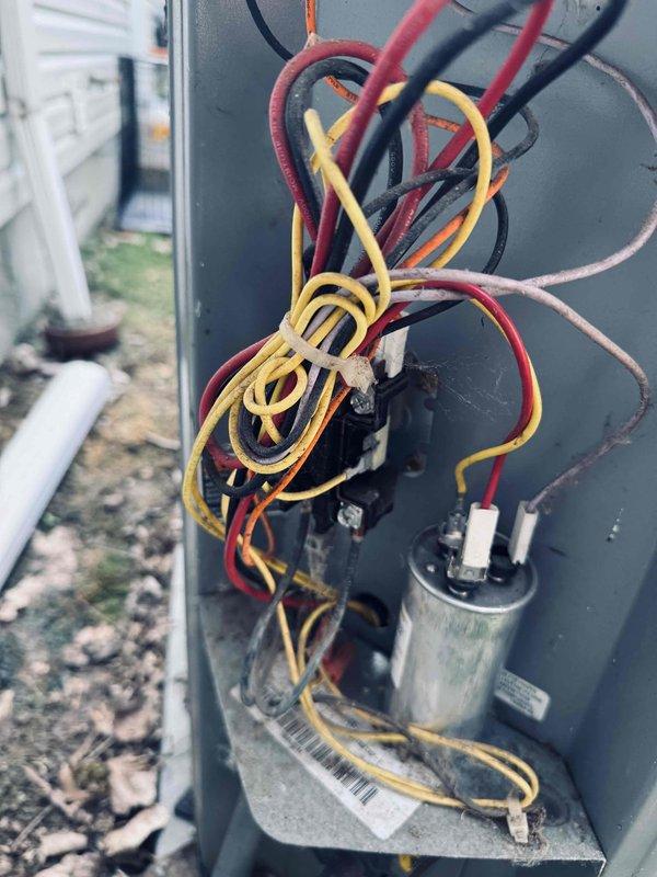 Responded to no cooling complaint and performed diagnostic inspection of air conditioning system. Upon examination of condensing unit, inspected electrical components including capacitor and wiring connections. All components appeared intact with proper wire routing and secure terminal connections observed during inspection.