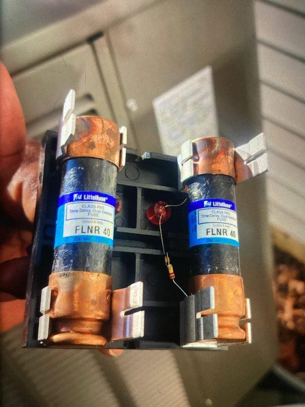 Completed preventive maintenance cooling visit on one-year-old air conditioning system. Inspected evaporator coil assembly, verified proper refrigerant line connections, and examined electrical components including dual-element 40-amp Littelfuse FLNR fuses in the disconnect. All systems operating within normal parameters with minor dust accumulation noted on coil surfaces.