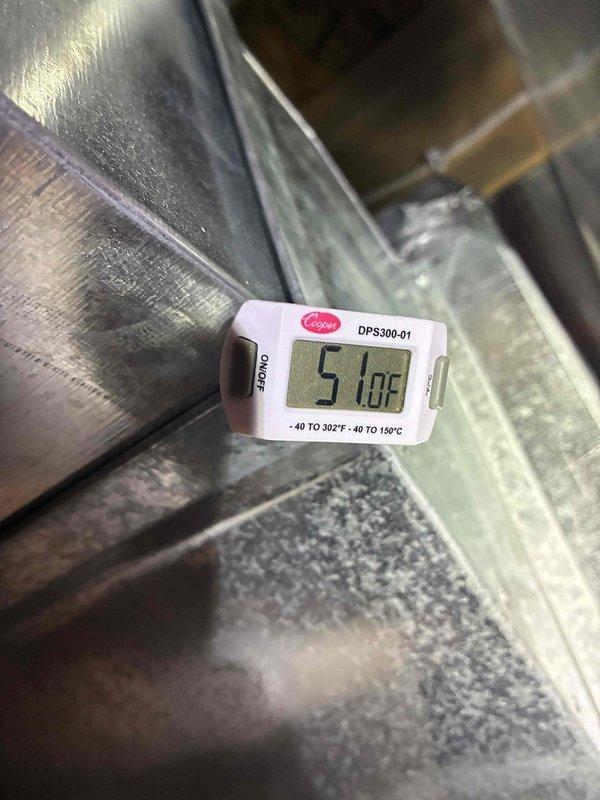 Completed routine air conditioning maintenance visit on an 8-year-old system. Performed system inspection with access panel removed, verified electrical connections including capacitor and contactor operation, and documented supply air temperature reading of 57°F at ductwork, confirming proper cooling performance.