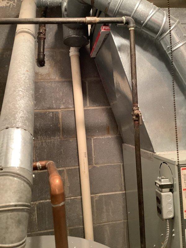 Conducted site assessment in basement mechanical room for potential waterline repair. Identified copper water supply line requiring attention located behind HVAC ductwork. Coordinated with HVAC department to schedule duct removal to access affected plumbing components. Documented existing conditions including vertical PVC drainage lines, copper supply piping with elbow joints, and proximity to mechanical equipment. Site photographed showing confined workspace in mechanical room and adjacent attic/crawl space access area with ductwork and insulated piping. Scheduled follow-up appointment to complete waterline repair once HVAC ductwork relocation is performed.