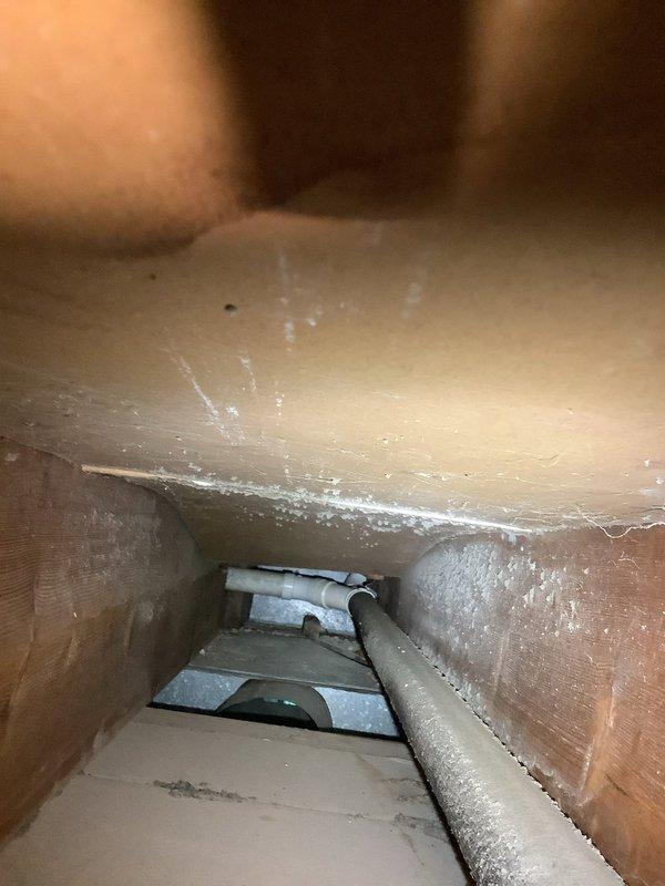 Conducted site assessment in basement mechanical room for potential waterline repair. Identified copper water supply line requiring attention located behind HVAC ductwork. Coordinated with HVAC department to schedule duct removal to access affected plumbing components. Documented existing conditions including vertical PVC drainage lines, copper supply piping with elbow joints, and proximity to mechanical equipment. Site photographed showing confined workspace in mechanical room and adjacent attic/crawl space access area with ductwork and insulated piping. Scheduled follow-up appointment to complete waterline repair once HVAC ductwork relocation is performed.