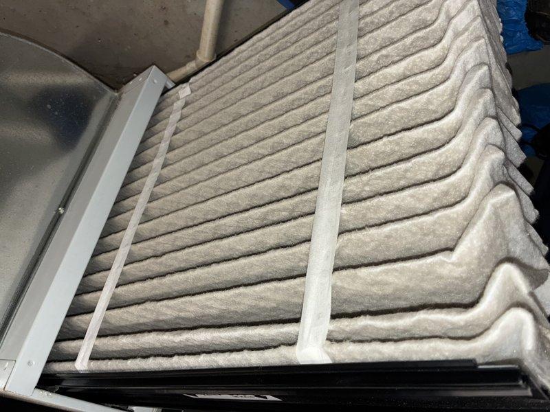 Completed scheduled air conditioning maintenance on 15-year-old system for MVP customer. Inspected and documented air filter condition showing moderate dust accumulation, and examined control board with all electrical connections and wiring harnesses intact and functioning properly. System operational and ready for cooling season.
