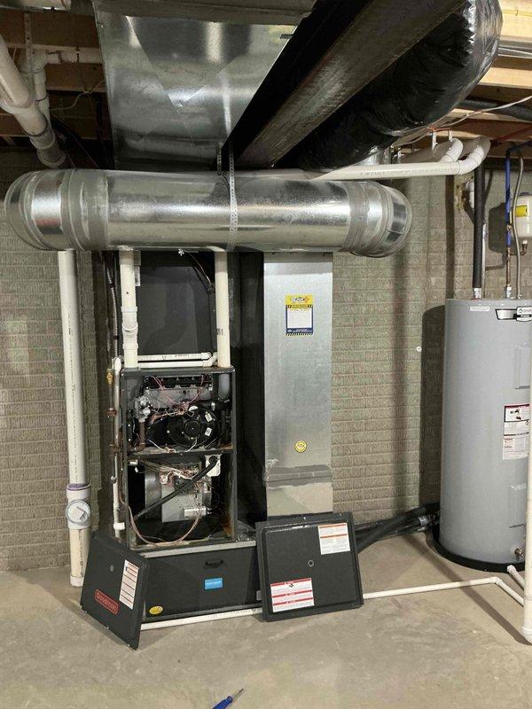 Conducted comprehensive HVAC system evaluation for potential replacement, documenting existing Goodman condensing unit and furnace installation. Customer requested leak search diagnostic despite identified cracked drain pan on current system, with photographic documentation completed of both indoor furnace/plenum assembly and outdoor condensing unit for estimate preparation.