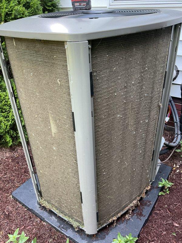 Completed annual cooling system maintenance visit on outdoor heat pump unit. Upon arrival, found condenser coils and air intake panels heavily soiled with accumulated dust, dirt, and debris, significantly restricting airflow. Performed thorough cleaning of exterior mesh grilles and condenser coils to restore proper ventilation and system efficiency. Inspected unit operation, refrigerant lines, and electrical connections. System is now operating within normal parameters with improved airflow following maintenance cleaning.