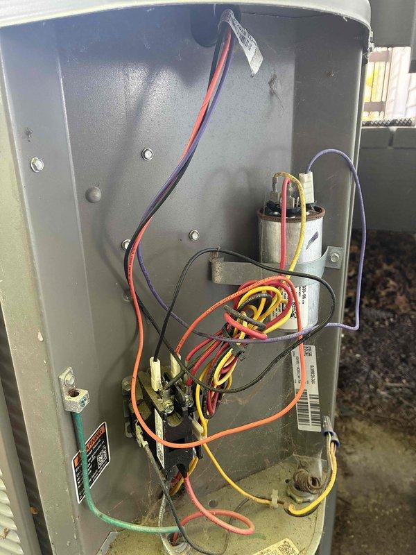 Performed routine maintenance on a three to four year old air conditioning system. Inspected electrical components including capacitors and wiring connections within the control compartment, verified all connections were secure and properly terminated. Measured supply air temperature at 55.2°F, confirming adequate cooling performance and proper system operation.
