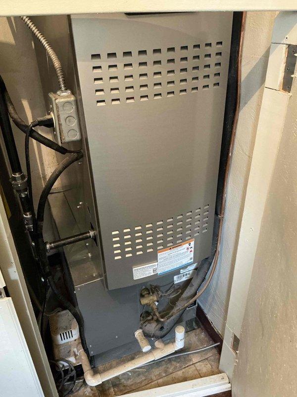 Performed estimate for complete HVAC system replacement on 10-year-old unit with major refrigerant leak in residential installation. Documented existing furnace and air handler configuration in utility closet, noting refrigerant lines, electrical connections, and drainage systems requiring replacement. Recommended full system replacement due to age and severity of leak.