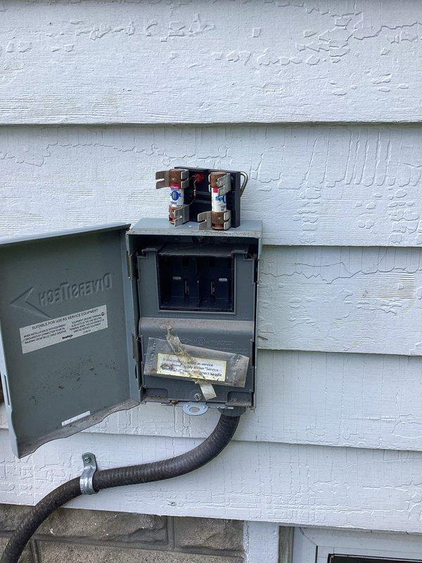 Completed MVP cooling maintenance visit on residential HVAC system over 10 years old. Performed comprehensive inspection of Rheem furnace unit located in basement utility area, verifying proper installation and operational status of vertical unit with dual PVC vent piping for intake and exhaust. Inspected exterior electrical components including disconnect box and meter socket mounted on building exterior, confirming secure connections and proper wire terminations with visible copper lugs. Documented system configuration and current condition of equipment through photographic records. All components found operational with no immediate service requirements identified during this routine maintenance inspection.
