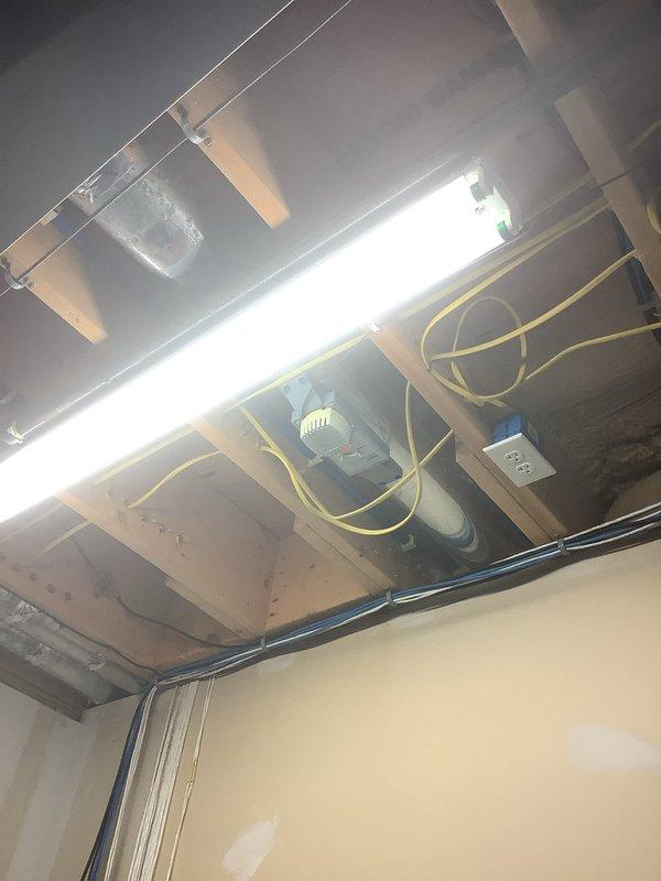 Responded to complaint of inconsistent airflow to basement area in home with multiple thermostats and 15-year-old geothermal system. Performed system evaluation and traced ductwork routing from geothermal unit serving main floor. Inspected basement zone dampers and duct distribution network in exposed ceiling areas to identify airflow restrictions and zoning control issues affecting basement conditioning.