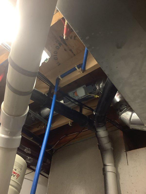 Responded to complaint of inconsistent airflow to basement area in home with multiple thermostats and 15-year-old geothermal system. Performed system evaluation and traced ductwork routing from geothermal unit serving main floor. Inspected basement zone dampers and duct distribution network in exposed ceiling areas to identify airflow restrictions and zoning control issues affecting basement conditioning.