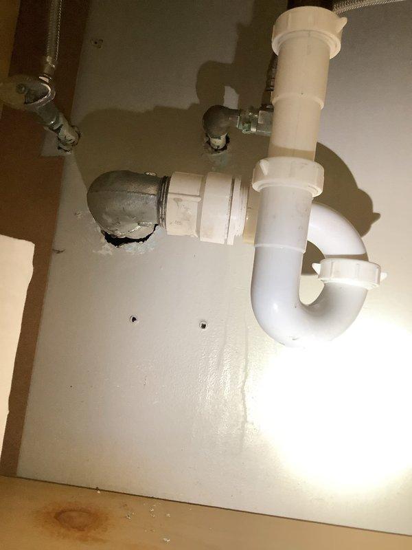 Responded to water leak complaint under bathroom sink. Upon inspection, identified leak at P-trap connection beneath basin. Tightened PVC coupling joints and verified proper seal at all connection points. Tested system by running water through drain line to confirm leak was resolved. All plumbing components functioning properly with no further water discharge detected.