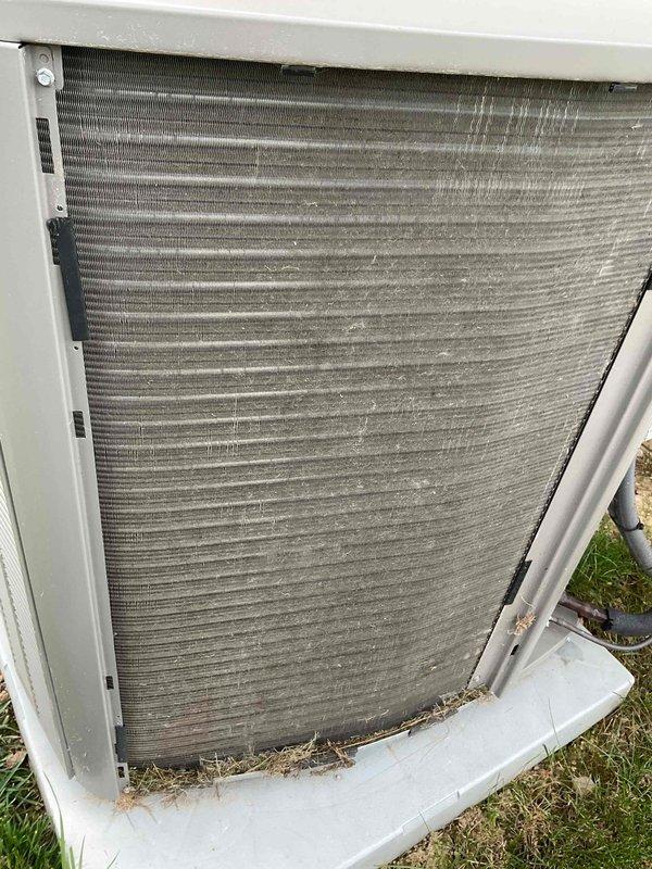Completed MVP recurring cooling maintenance on dual-system residential HVAC installation. Performed comprehensive inspection and preventive maintenance on both outdoor condenser units, including examination of condenser coils which showed moderate accumulation of dust, debris, and environmental contaminants typical of two-year-old equipment. Documented equipment condition through photographs showing exterior condenser placement, coil condition with visible fin buildup, and base pan debris accumulation including grass clippings and outdoor material. Verified refrigerant line connections and assessed overall system operation. Both units operational upon completion of scheduled maintenance visit.