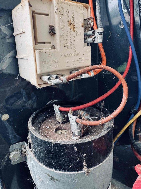 Responded to no cooling complaint on aging air conditioning system. Upon inspection, found failed dual run capacitor with visible deterioration and corrosion on contactor assembly. Replaced capacitor, cleaned electrical connections, and verified proper amperage draw on compressor and condenser fan motor. System restored to normal cooling operation with all components operating within manufacturer specifications.