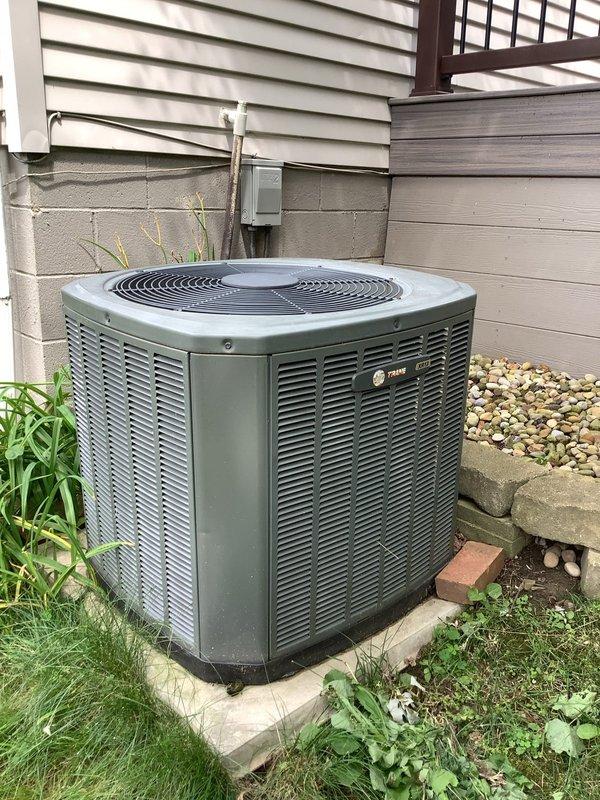 Responded to no-start condition on Trane outdoor condensing unit. Upon inspection, found dual run capacitor severely deteriorated with heavy rust and corrosion on terminals and casing. Replaced failed capacitor, verified proper electrical connections, and tested system operation. Unit now running properly with normal amperage draw and cooling cycle.