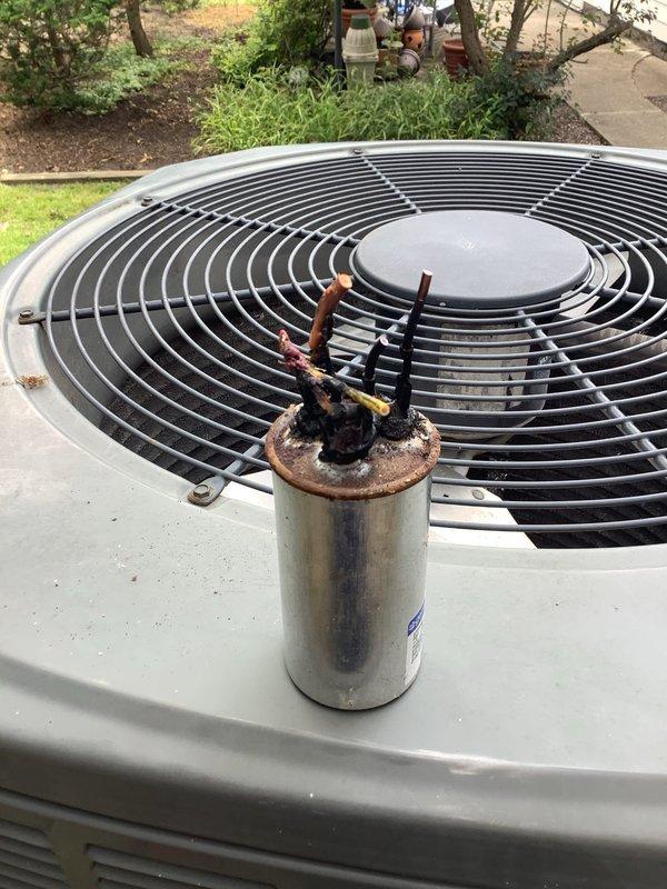 Responded to no-start condition on Trane outdoor condensing unit. Upon inspection, found dual run capacitor severely deteriorated with heavy rust and corrosion on terminals and casing. Replaced failed capacitor, verified proper electrical connections, and tested system operation. Unit now running properly with normal amperage draw and cooling cycle.