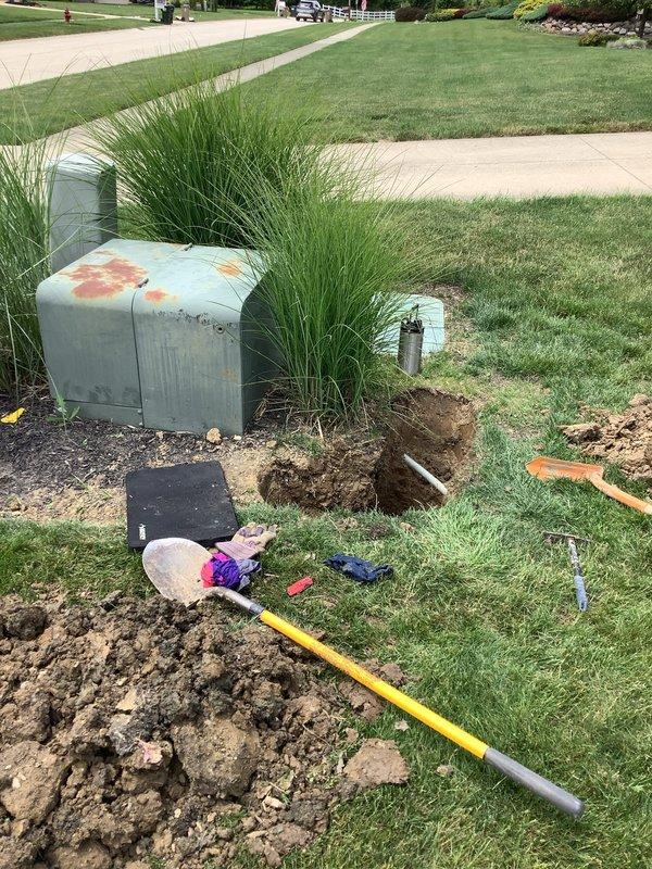Underground service wire repair completed after damage caused by third-party fiber optic installation. Excavated area near exterior utility box to locate and access broken conductor, performed underground splice using approved materials and methods to restore electrical service. Backfilled excavation and restored yard area upon completion.