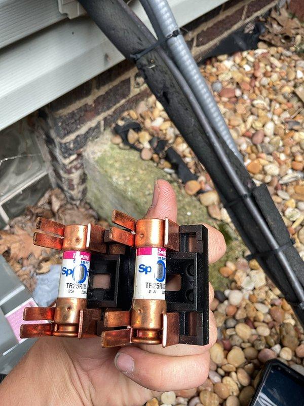 Completed MVP cooling maintenance visit on residential HVAC system. Inspected electrical components within outdoor condensing unit, identifying two blown 2-amp fuses (SPD and TRD5RE rated) that required replacement. Removed failed fuses from their black plastic holders and installed new fuses to restore proper system operation. Examined capacitor, contactor assembly, and associated wiring connections, noting normal wear consistent with system age. All electrical connections were secure with proper wire management in place. System tested and confirmed operational following fuse replacement.